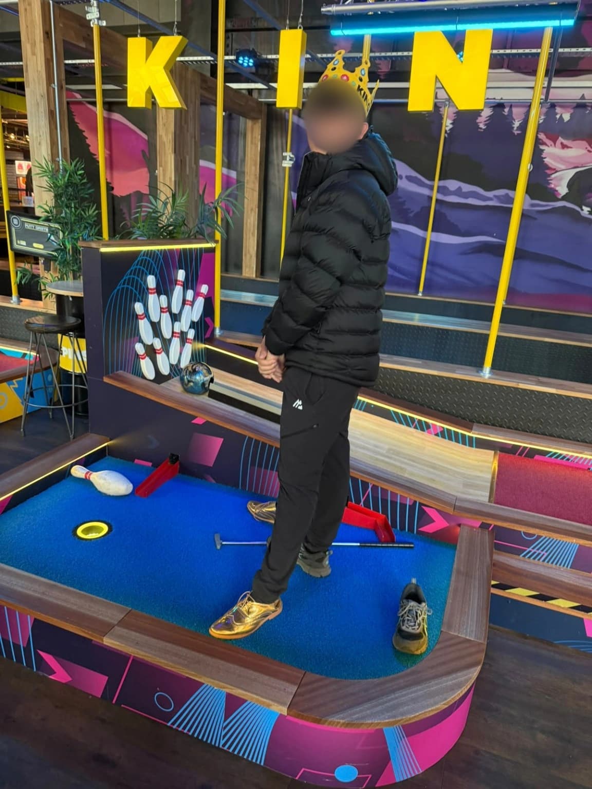 A learner taking part in a mini golf enrichment activity.