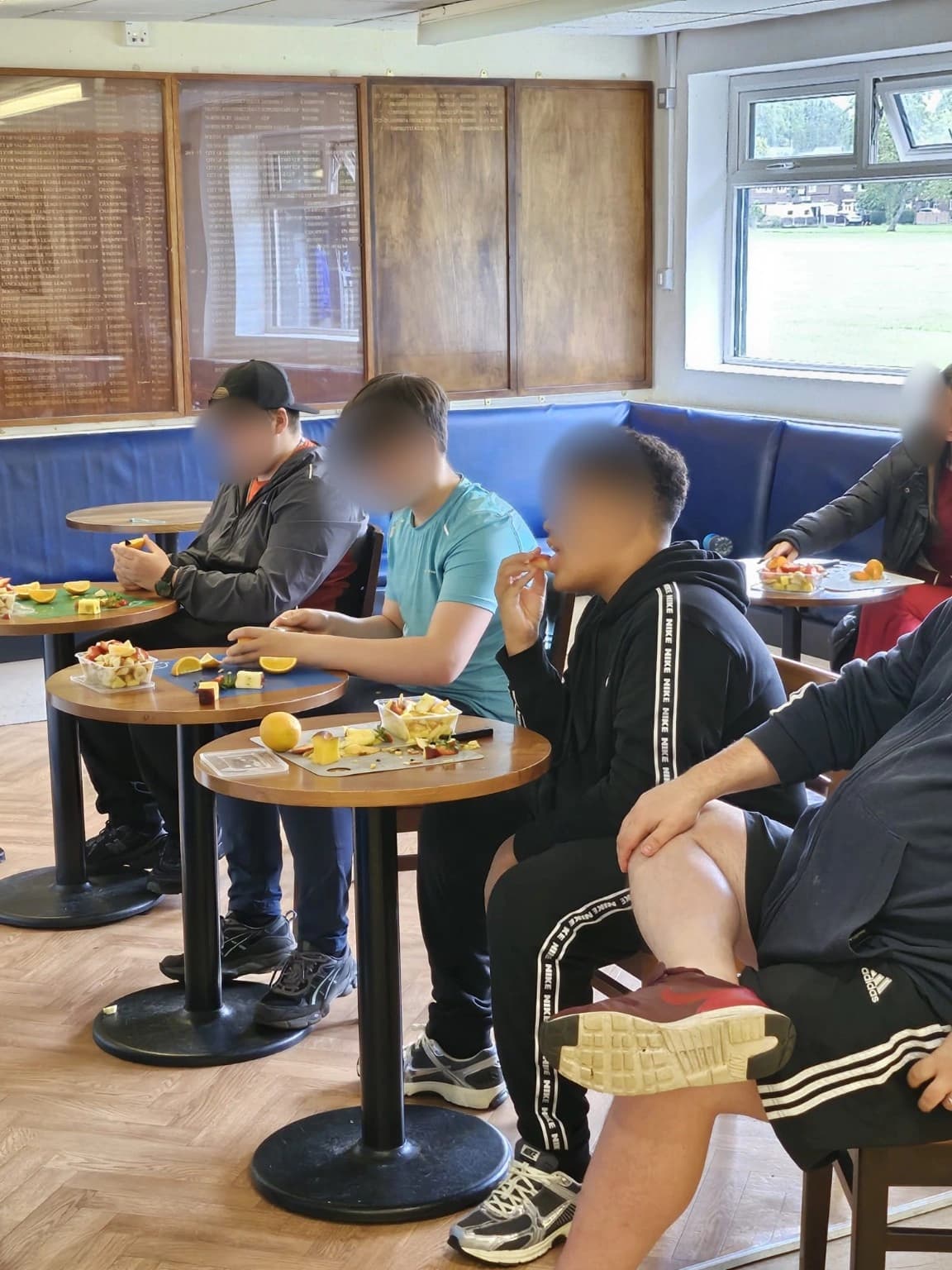 Learners preparing and tasting fruit during a practical healthy eating session.